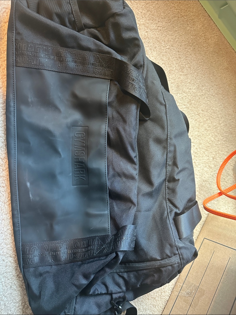 Gymshark Black Duffel Bag with Embossed Logo and Shoulder Strap